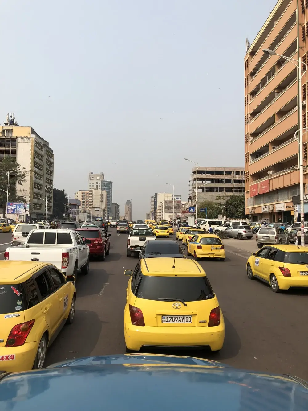 Heavy yellow-taxi traffic on Boulevard du 30 Juin in Gombe, Kinshasa